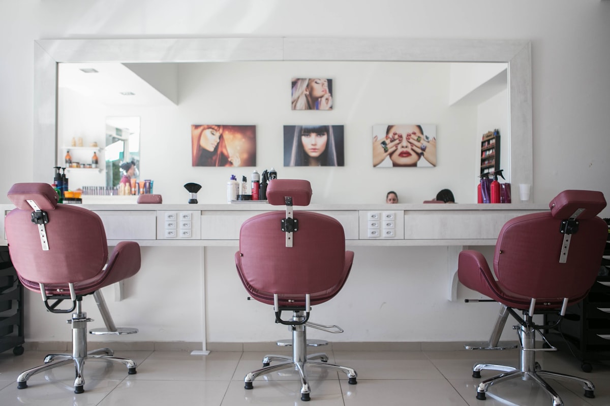 Barber at work in a warmly-lit barbershop